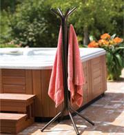 Towel tree with two pink hanging towels next to hot tub 