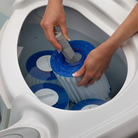 Overhead View Of Person’s Hands Changing Hot Tub Filter