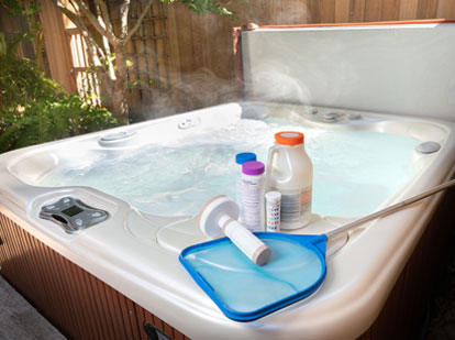 skim screen, bromine float and chemical on top of an outdoor hot tub