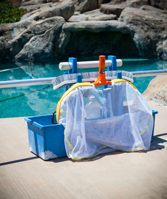 pool cleaning equipment in front of a luxurious pool