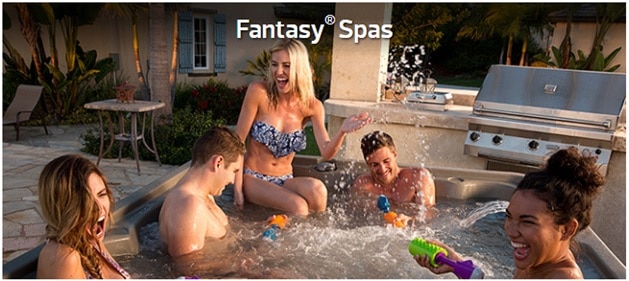Five people splashing and laughing in Fantasy Spa hot tub