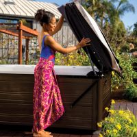 Woman removing hot tub lid using the UpRite Cover Lifter