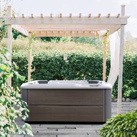 A Hot Tub Located Under A Pergola