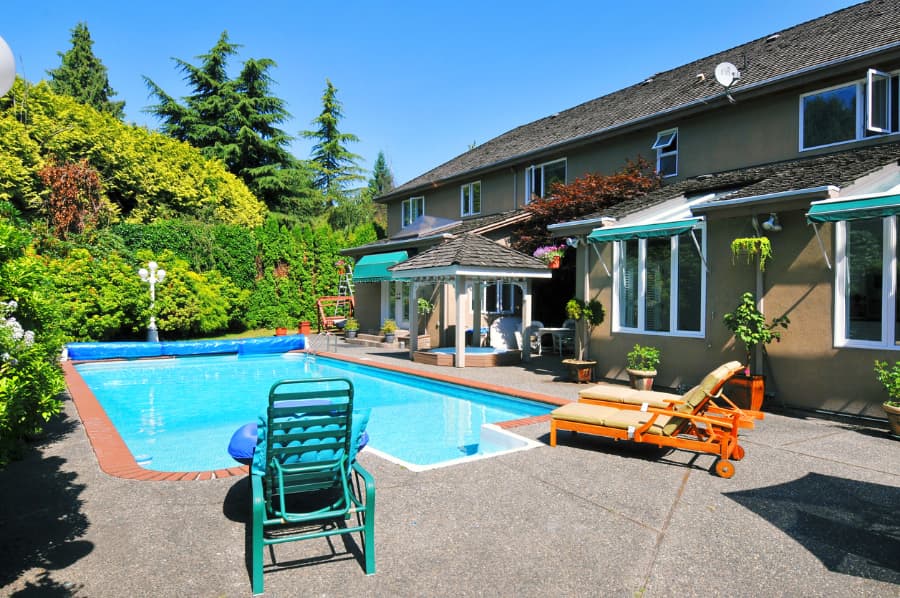 inground pool in a beautifully landscaped backyard