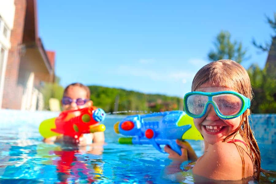 Kids With Water Guns In Pool