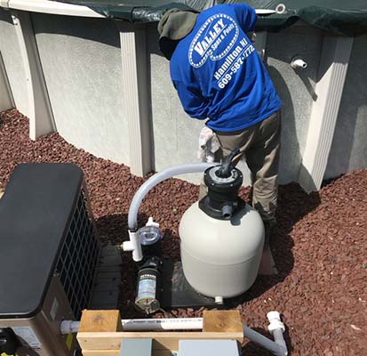 Pump And Filter System In Front Of Exterior Of Above-Ground Pool 