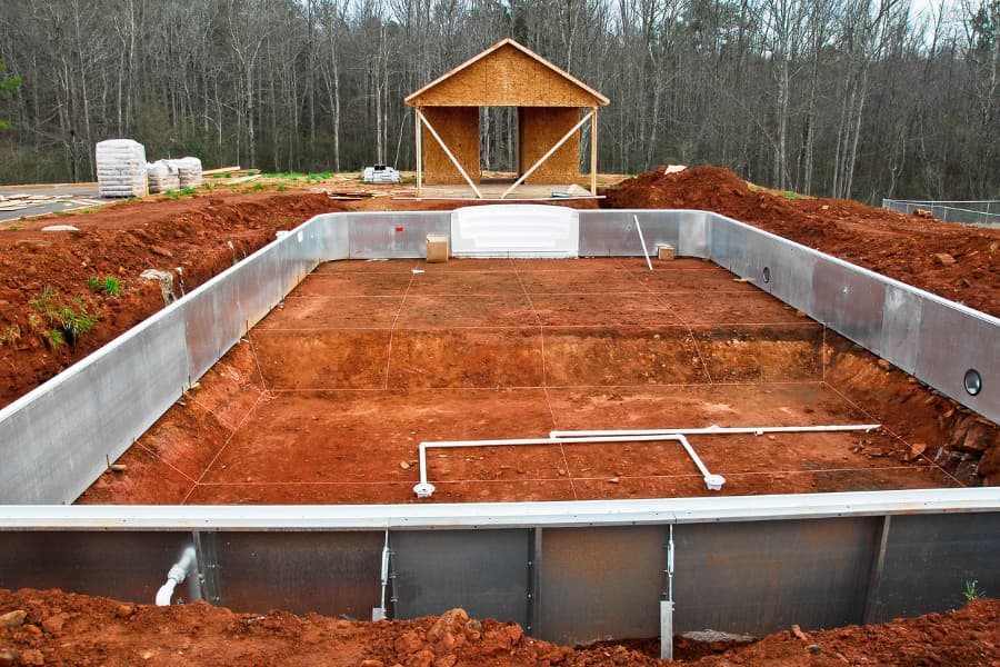 A New In-Ground Swimming Pool Being Installed In A New Housing Development