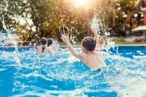 Children Splashing and Having Fun in Swimming Pool 